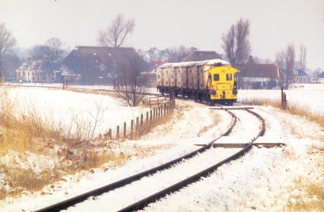 Locomotor 341(bijgenaamd sik), bedoeld voor lichte goederentreinen en rangeerwerkzaamheden, met een sleep koelwagens nabij Jelsum op weg van Stiens van Leeuwarden. op 21 februari 1994. Foto: Hans Elzinga.